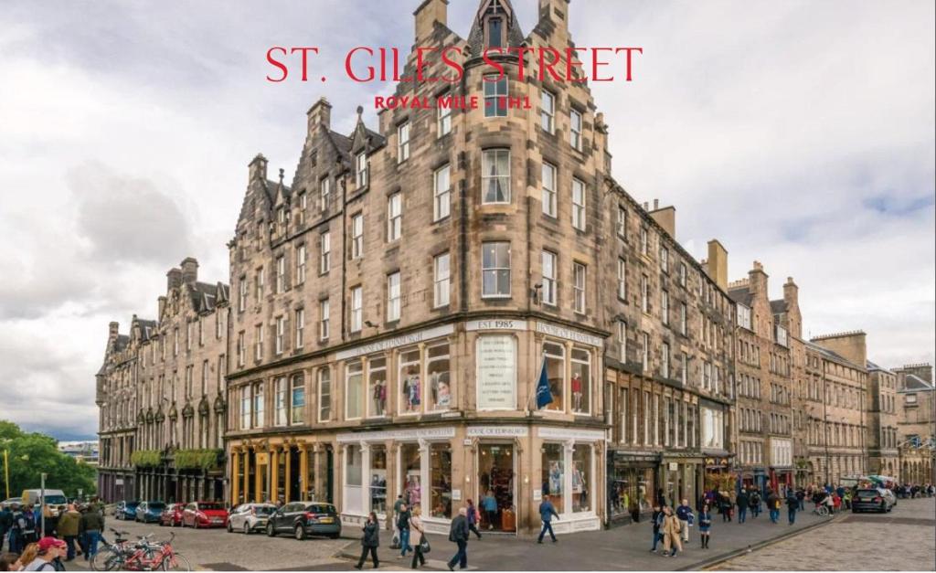 a large building with people walking in front of it at Royal Mile St Giles St in Edinburgh