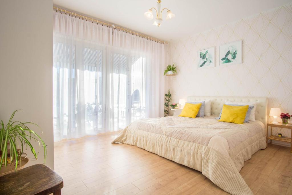 a bedroom with a bed with yellow pillows on it at Spacious apartment by the sea 8+4 in Pula