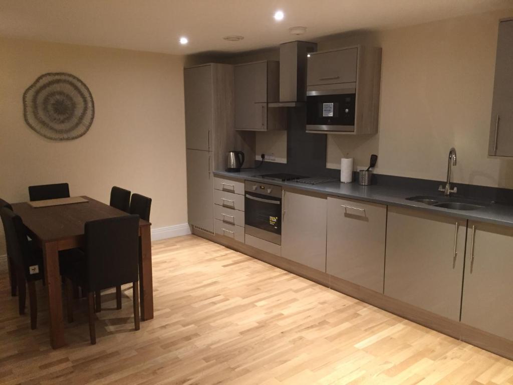 a kitchen with a table and a dining room at Stockley Near Heathrow in Yiewsley