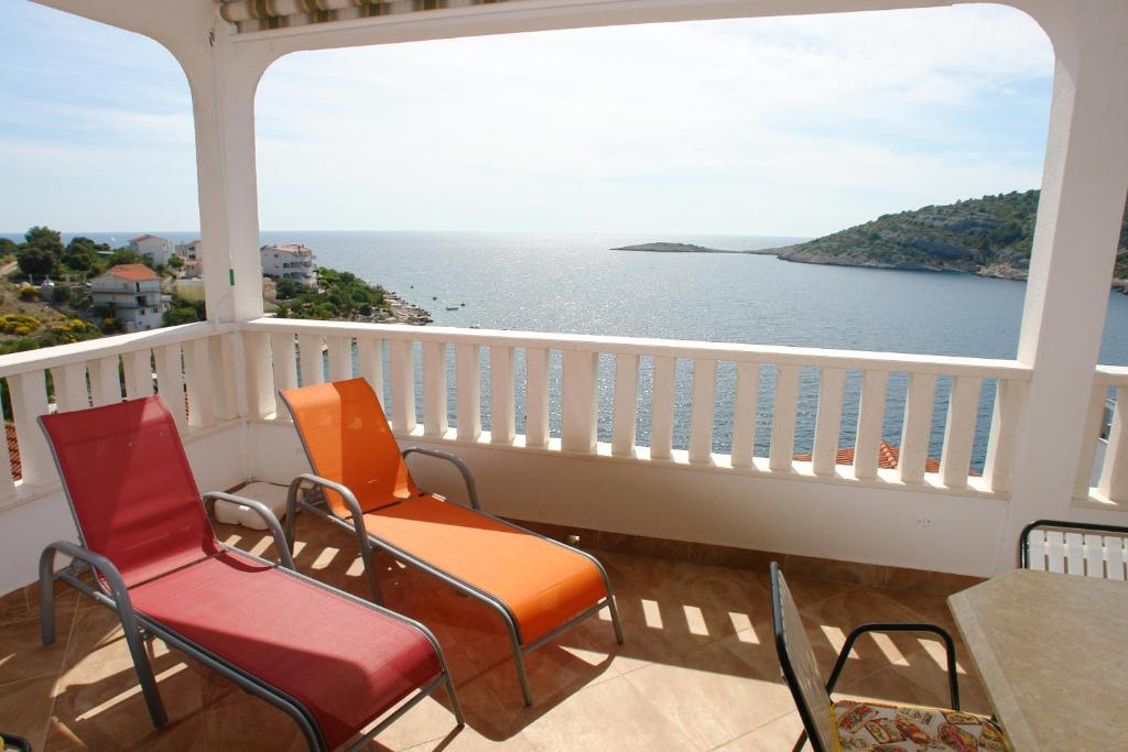 a balcony with chairs and a view of the ocean at Apartments Lucija in Ražanj