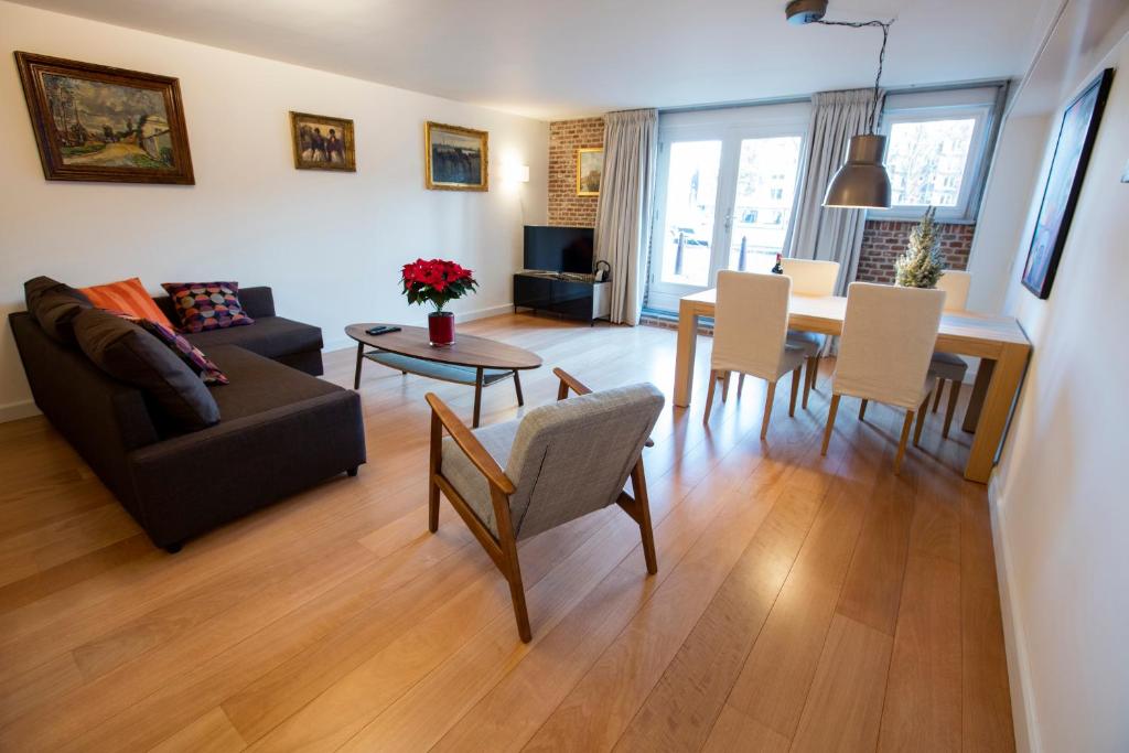 a living room with a couch and a table at Central & Quiet Canal Apartment in Amsterdam