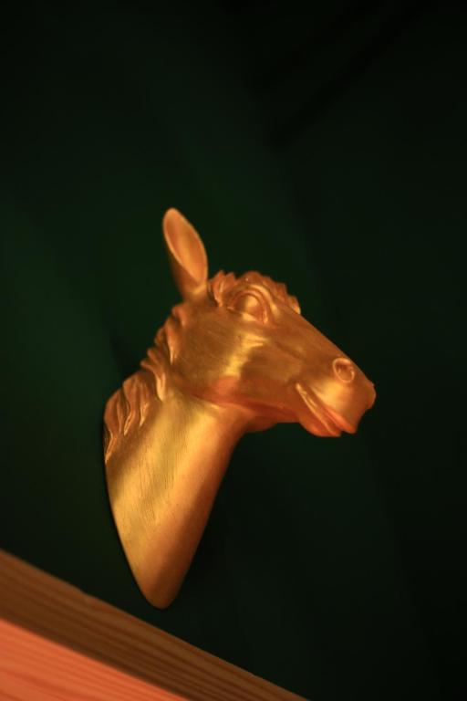a bronze head of a horse on a shelf at Kenting Original Hostel in Kenting