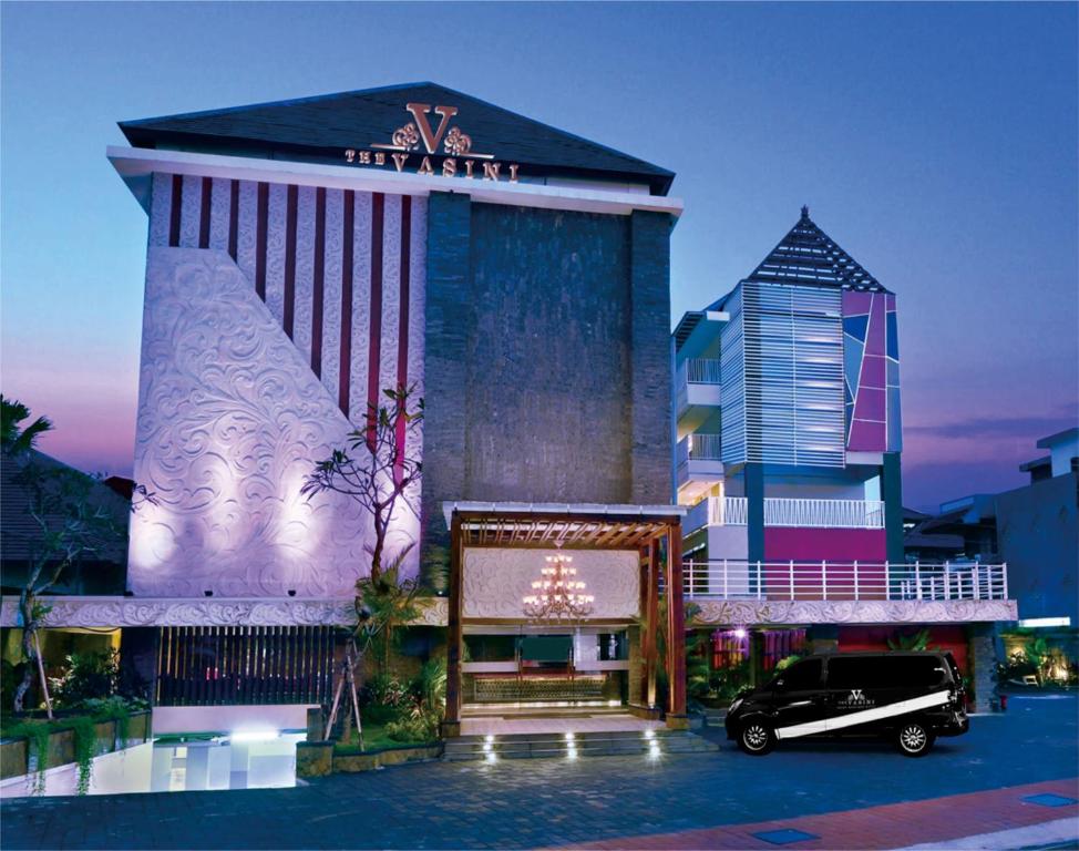 a building with a christmas tree in front of it at The Vasini Hotel in Denpasar