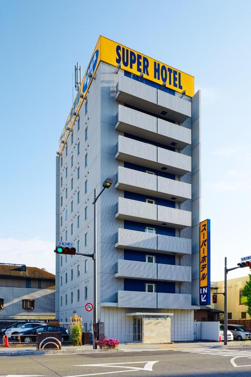 a hotel building with a super hotel sign on it at Super Hotel Ogaki Ekimae in Ogaki