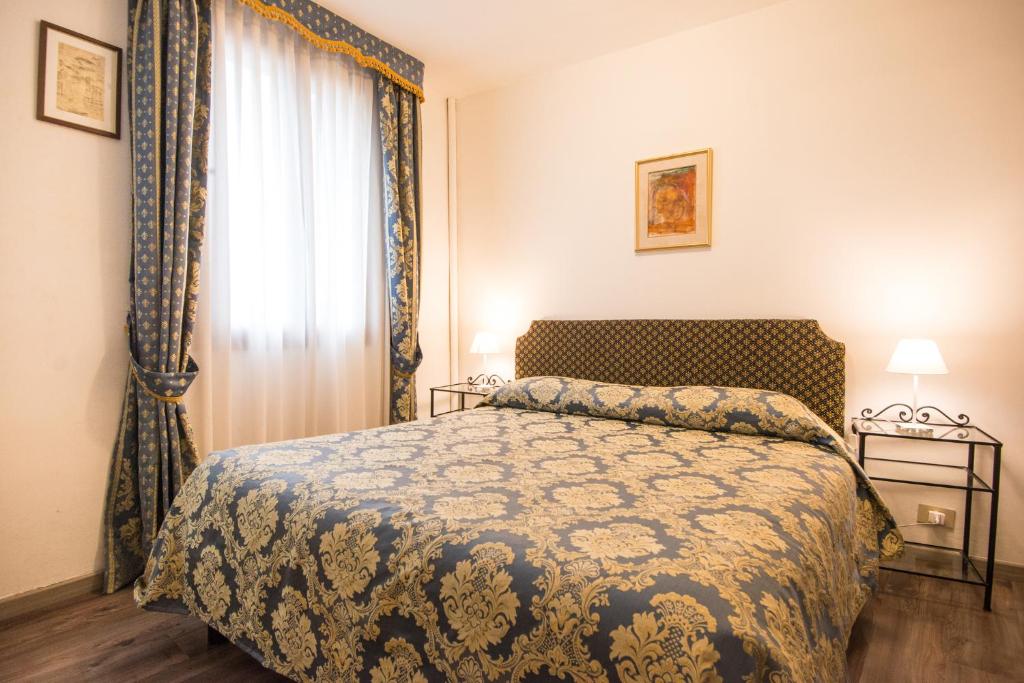 Postel nebo postele na pokoji v ubytování Albergo Casa Peron