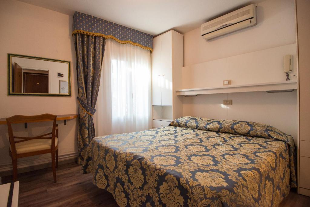 Postel nebo postele na pokoji v ubytování Albergo Casa Peron