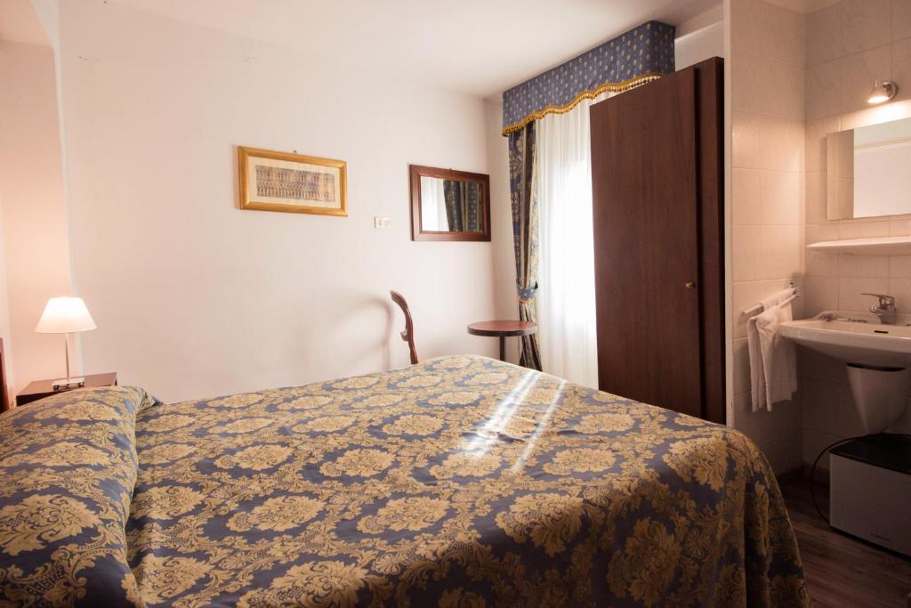 Postel nebo postele na pokoji v ubytování Albergo Casa Peron