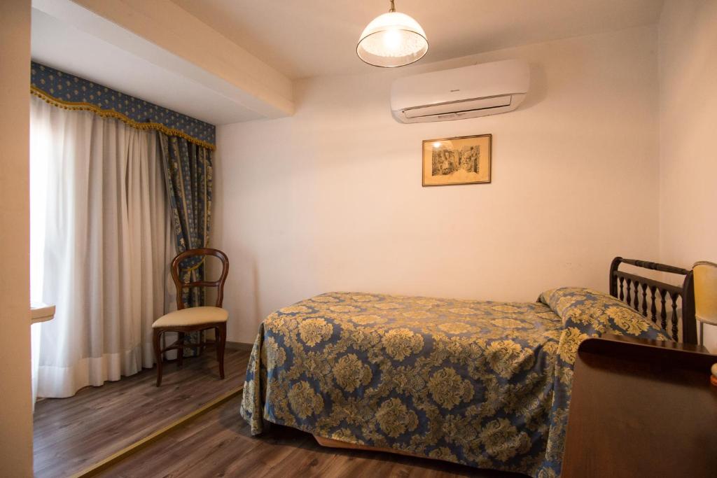 Postel nebo postele na pokoji v ubytování Albergo Casa Peron