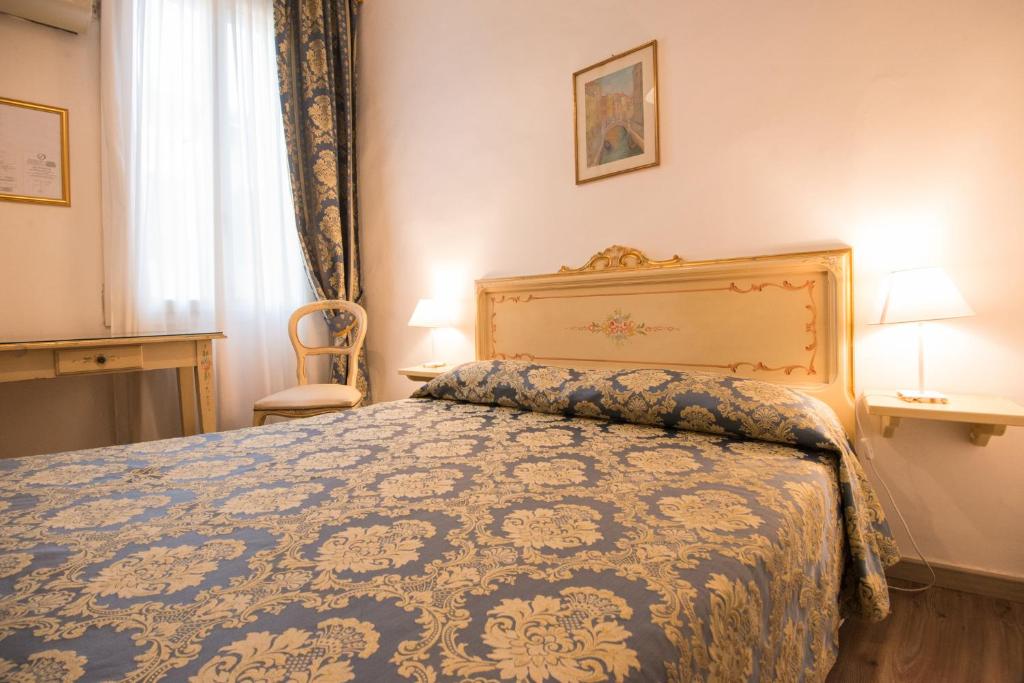 Postel nebo postele na pokoji v ubytování Albergo Casa Peron