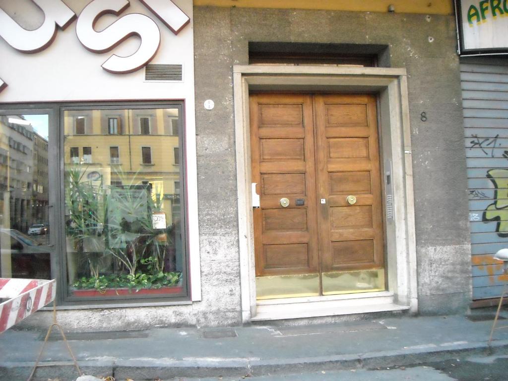 a building with a wooden door on the side of it at B&B SILVANO in Bologna