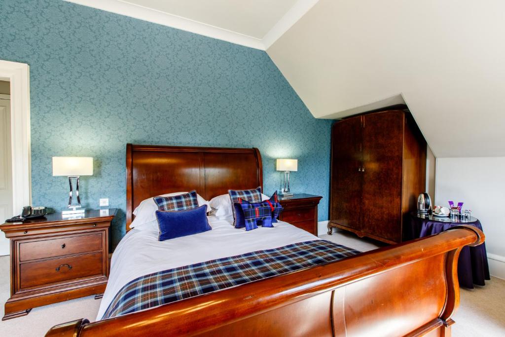 Postel nebo postele na pokoji v ubytování Tor-Na-Coille Hotel