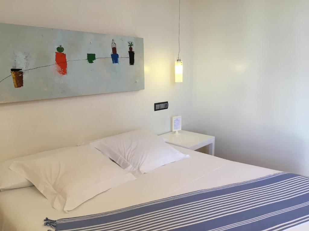 1 dormitorio con 1 cama y una pintura en la pared en Hotel Nochendi en Cangas de Onís