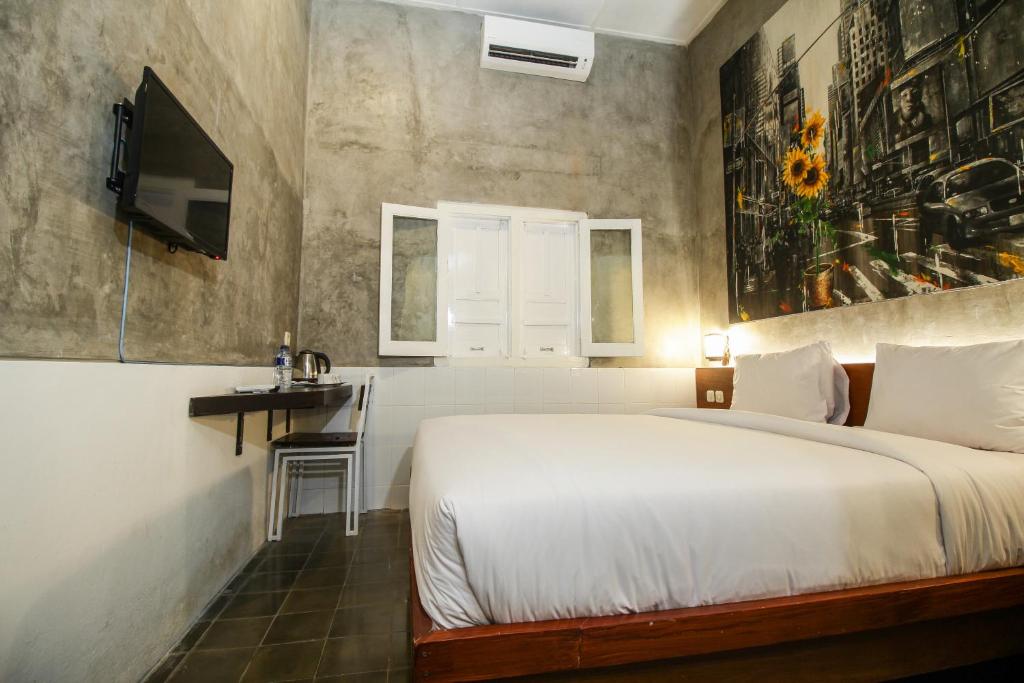 Postel nebo postele na pokoji v ubytování Watu Agung Guest House