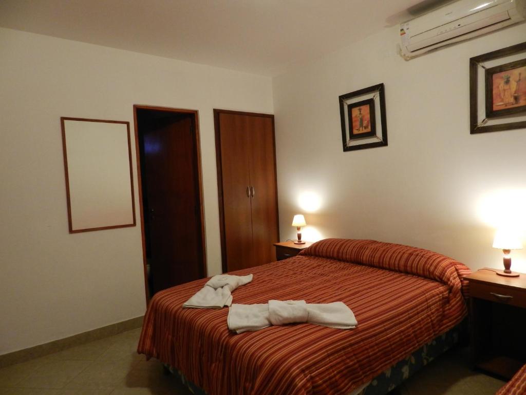 a hotel room with a bed with towels on it at Hotel Buenos Aires in Salta