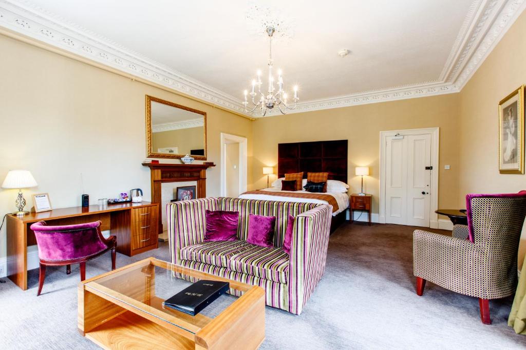 a living room with a couch and a bed at Tor-Na-Coille Hotel in Banchory