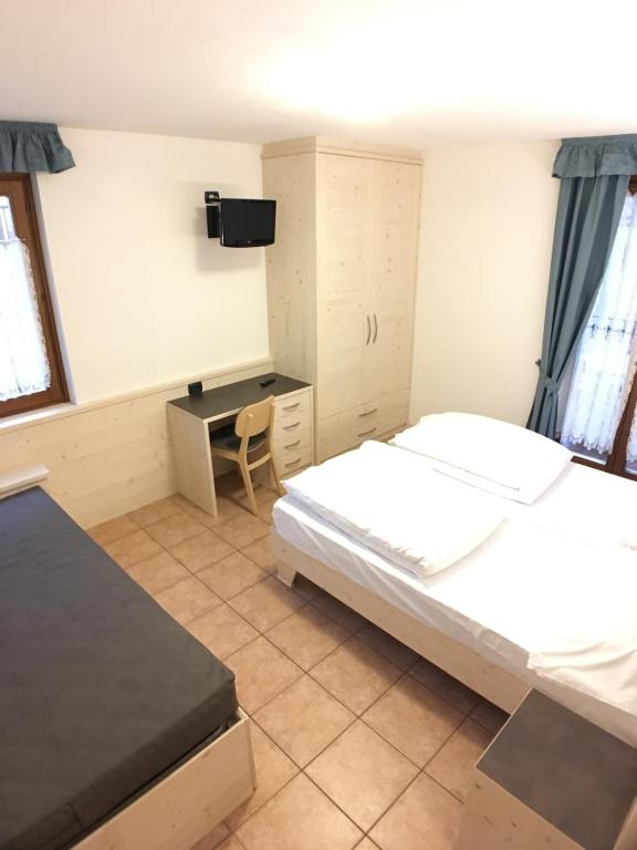 Postel nebo postele na pokoji v ubytování Residence Cima Tosa