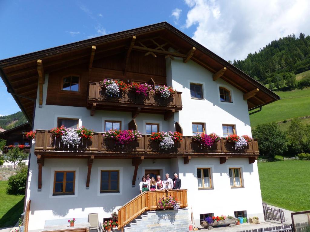 a group of people standing on the balcony of a building at Moarhof in Thurn