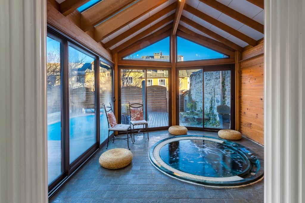 a house with a pool in a room with windows at Le Rendez Vous de Vauban Gites & Spa in Mont-Dauphin