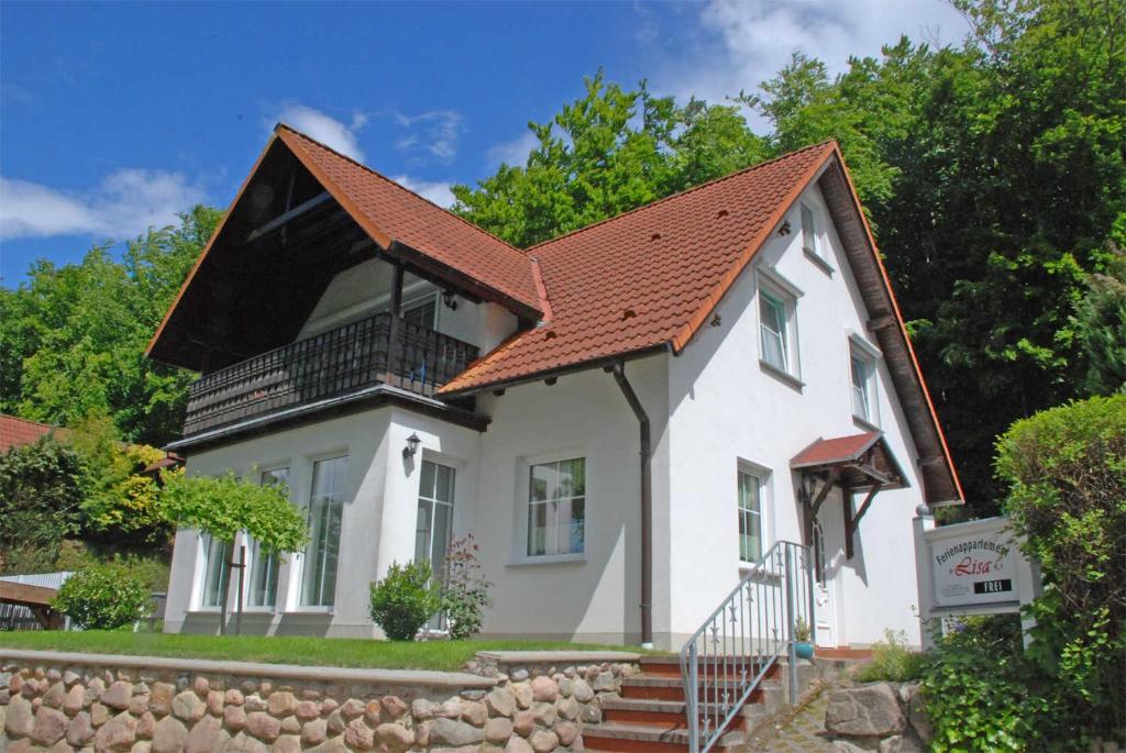 a white house with a brown roof at Ferienappartement Lisa in Ostseebad Sellin