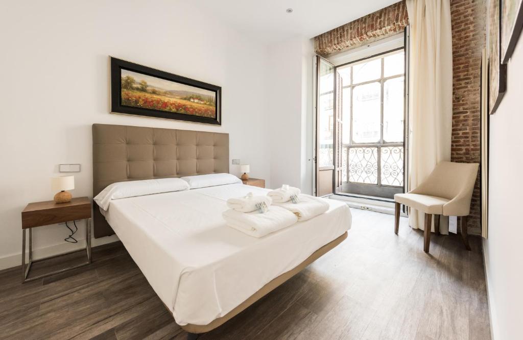 A bed or beds in a room at Puerta Del Sol City Center