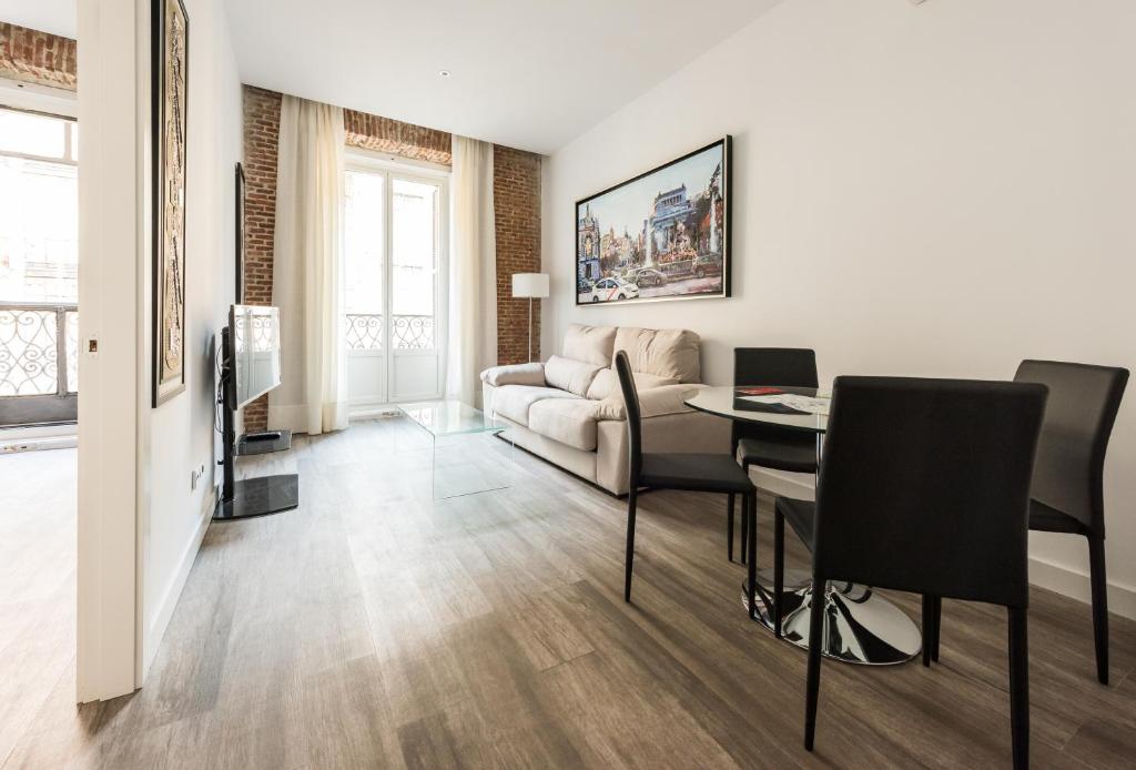 a living room with a couch and a table at Puerta Del Sol City Center in Madrid