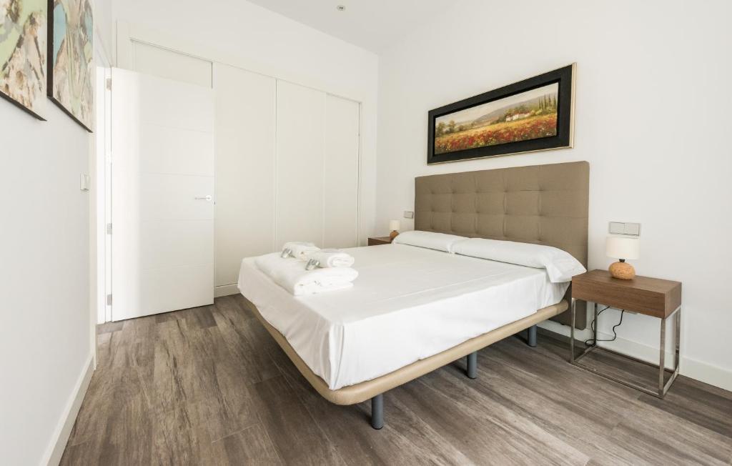 A bed or beds in a room at Puerta Del Sol City Center