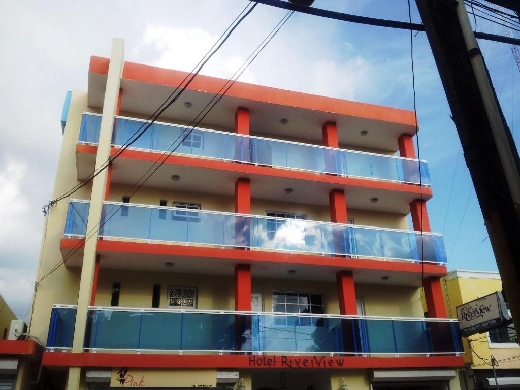 a building with a balcony on the side of it at Hotel Boutique River View La Romana in La Romana