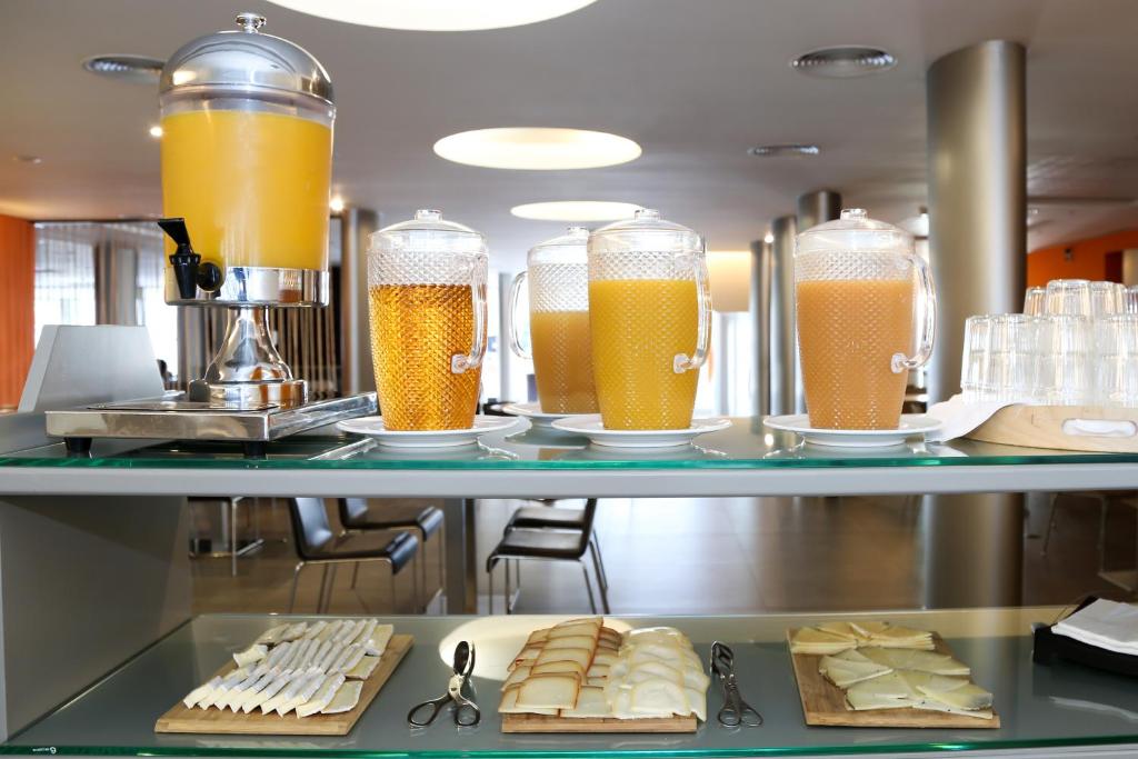 a row of glasses of beer on a shelf at Hotel Praia in Nazaré