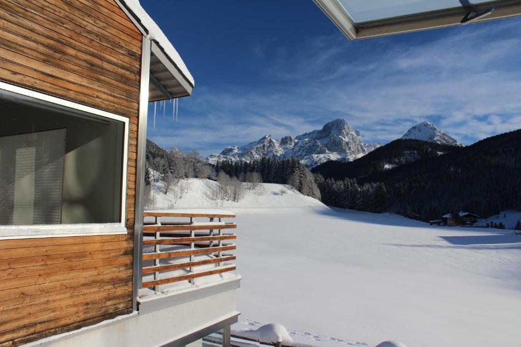 a view of the mountains from a house in the snow at Haus Walter in Filzmoos