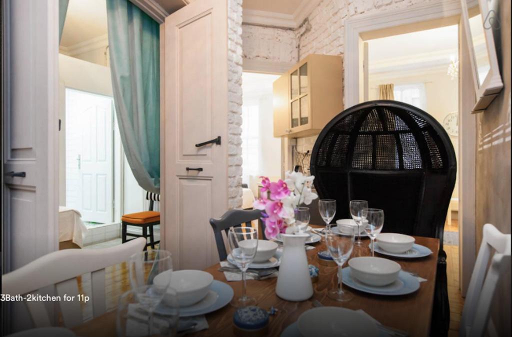 a dining room with a table with plates and glasses at Galata Chic Delux Flats in Istanbul
