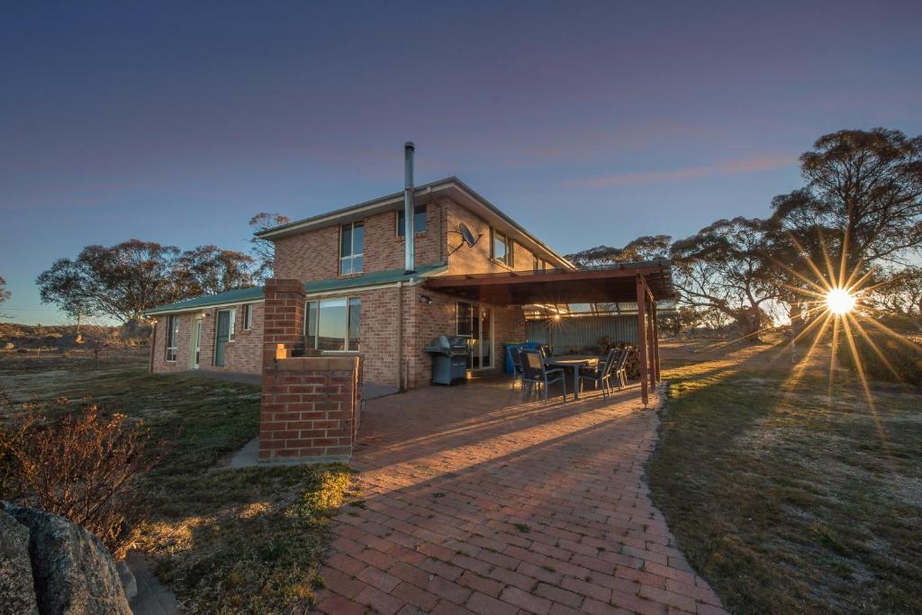 a house with a brick pathway leading to a patio at Alpine Drovers Rest 20 Iron Pot Creek in Jindabyne