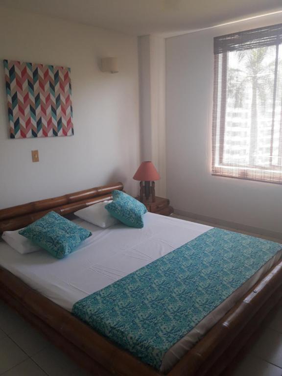 Postel nebo postele na pokoji v ubytování girardot resort apto102