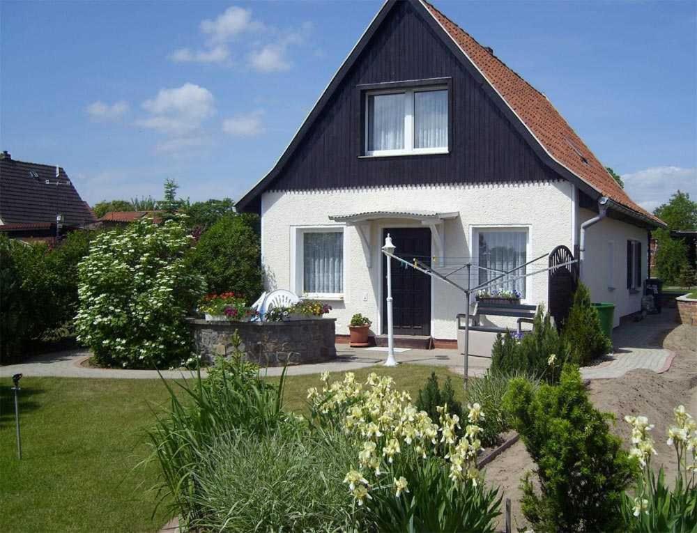 a small white house with a black roof at Ferienhaus Plau am See SEE 4231 in Plau am See