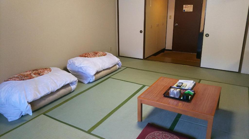 Postel nebo postele na pokoji v ubytování Itoen Hotel Hakone Yumoto