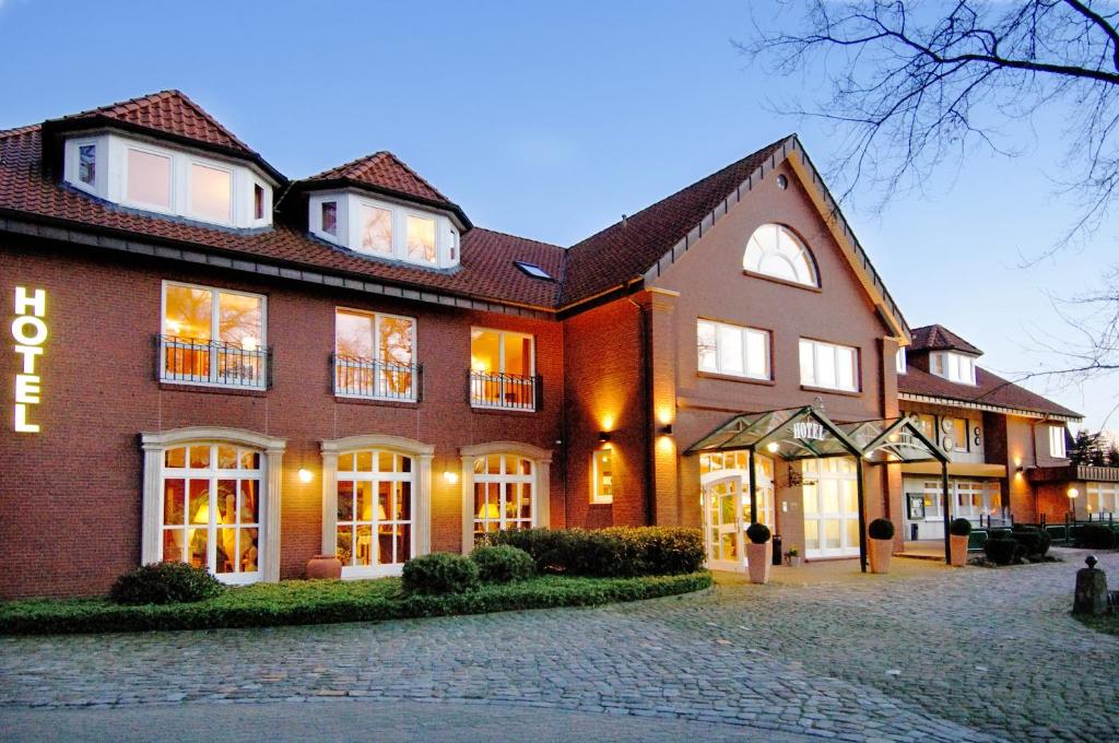 a large red brick building with a lot of windows at Landgut Stemmen in Stemmen