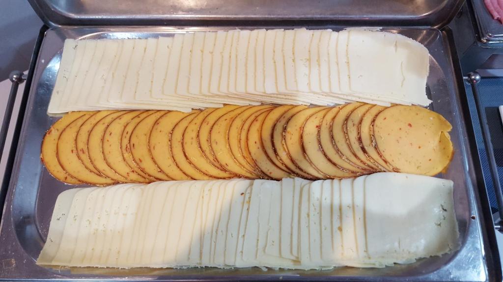 a plastic container filled with cheese and banana slices at Water's Edge Hotel in Birżebbuġa