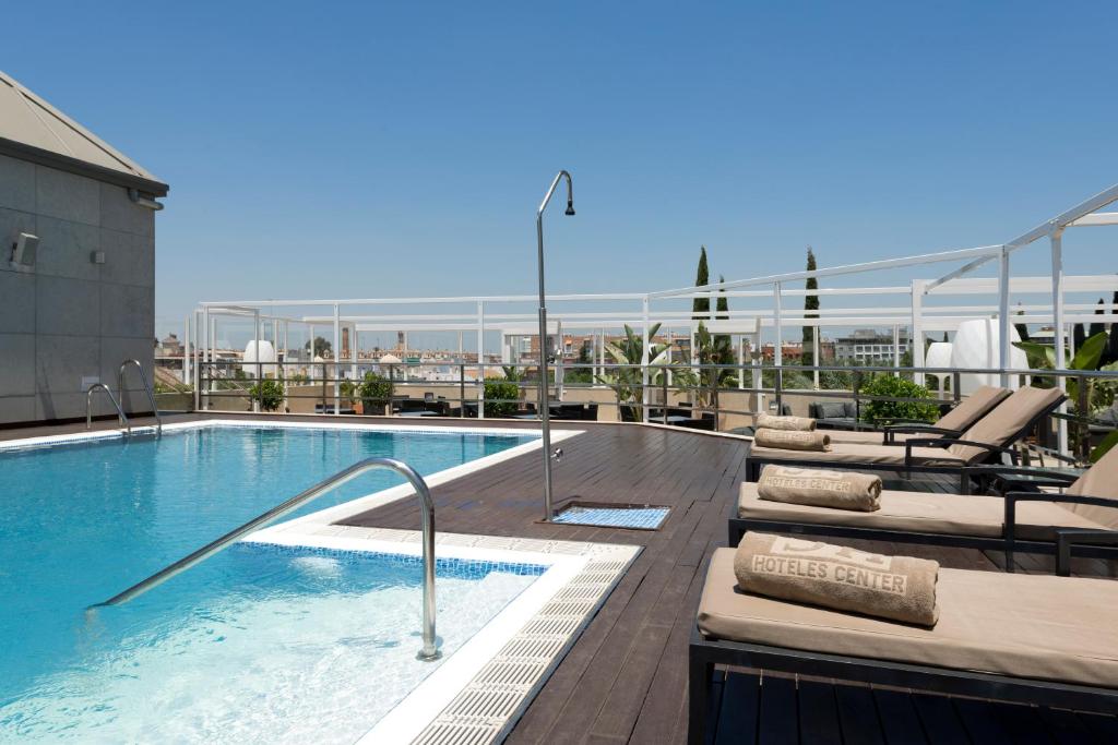 a swimming pool on top of a building at Hotel Sevilla Center in Seville