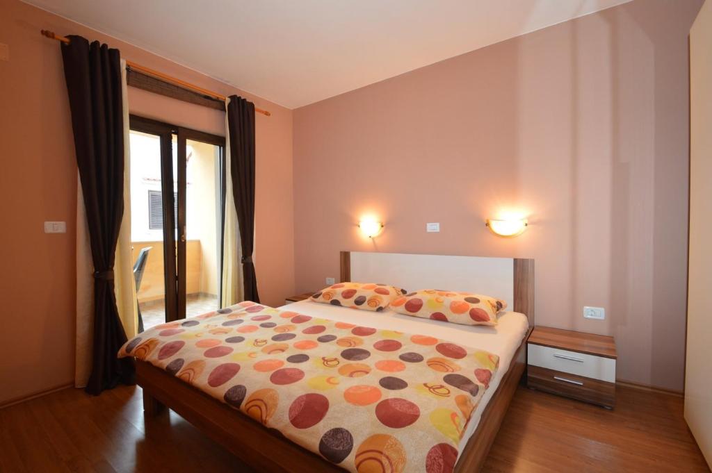 a bedroom with a bed in a room with a window at Christian in Mali Lošinj