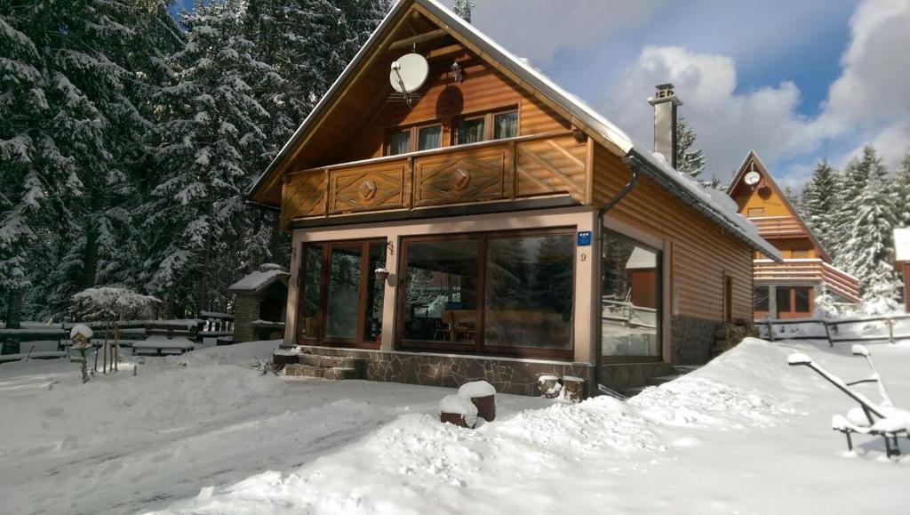 a house is covered in snow in front at Holiday Home Jela in Mrkopalj