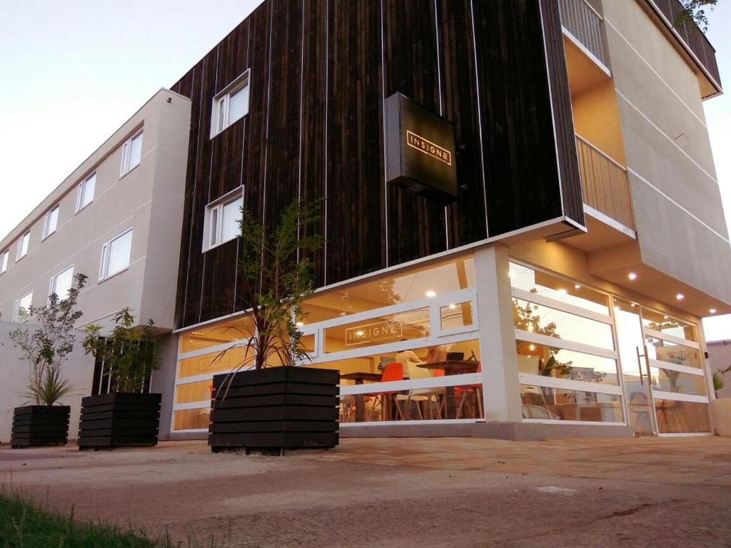 a building with a sign on the side of it at Hotel Insigne in Talca