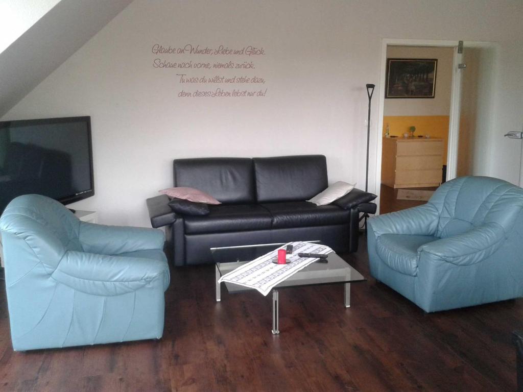 ein Wohnzimmer mit 2 Stühlen und einem Sofa in der Unterkunft Luxuswohnung, 90 qm, Balkon, beste Lage in Kollmar in Kollmar