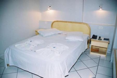 Postel nebo postele na pokoji v ubytování Hotel Topazio Ltda