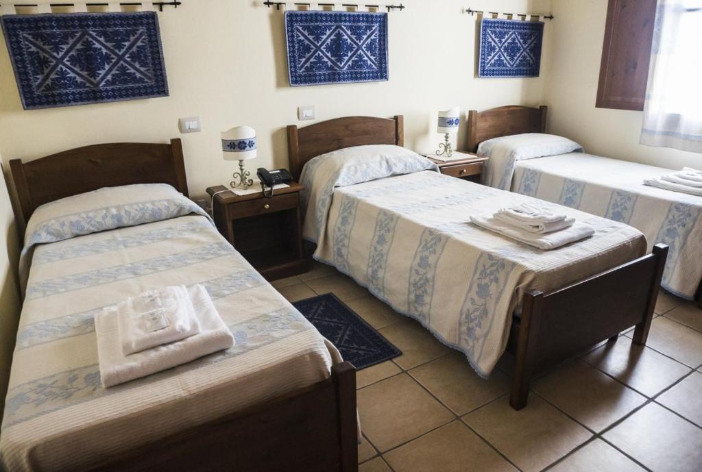 Postel nebo postele na pokoji v ubytování Albergo Diffuso Il Mandorlo