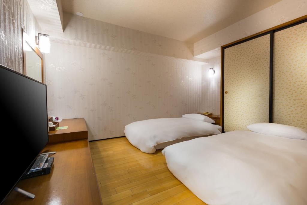 Postel nebo postele na pokoji v ubytování Lishin Hotel