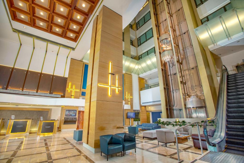 a lobby of a hospital with chairs and stairs at Catalonia Santo Domingo in Santo Domingo