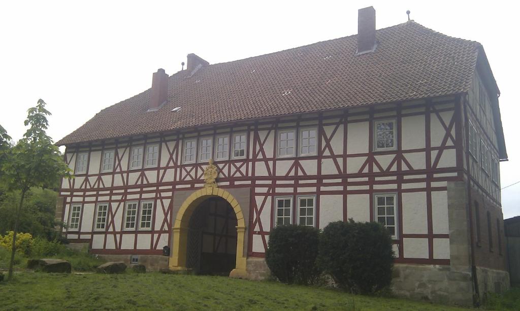 an old building with an arch in a field at Domäne Paterhof in Duderstadt