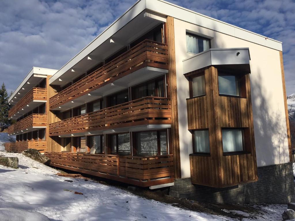 a building with wood paneling on it in the snow at Le Solaret in Courchevel