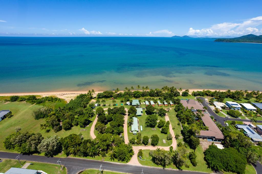 an aerial view of a park next to the water at King Reef Resort in Kurrimine Beach