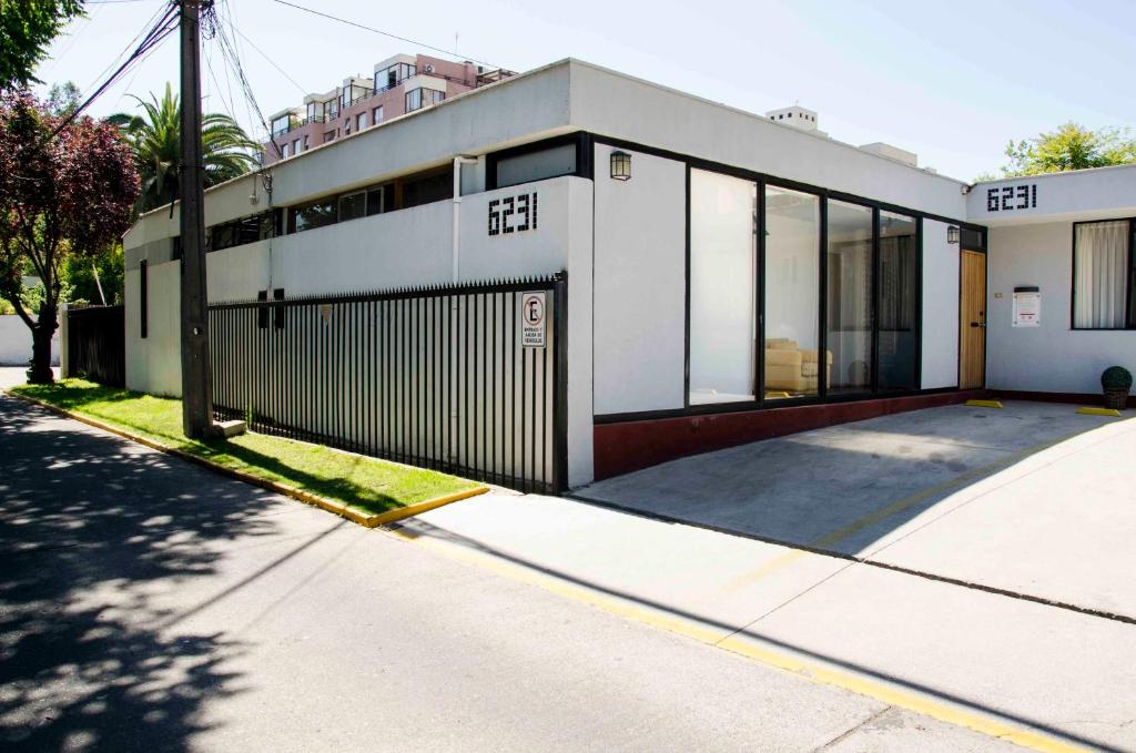 a white building with a gate on a street at Bed and Breakfast Manque in Santiago