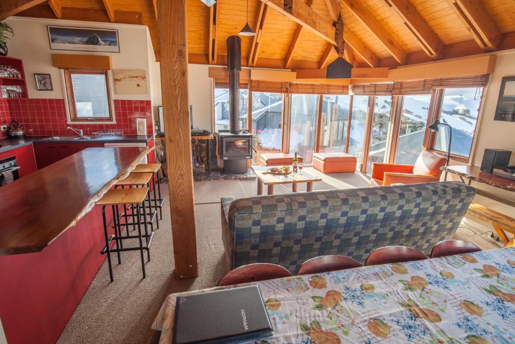 a kitchen with a couch and a counter in a room at Nolyski in Mount Hotham